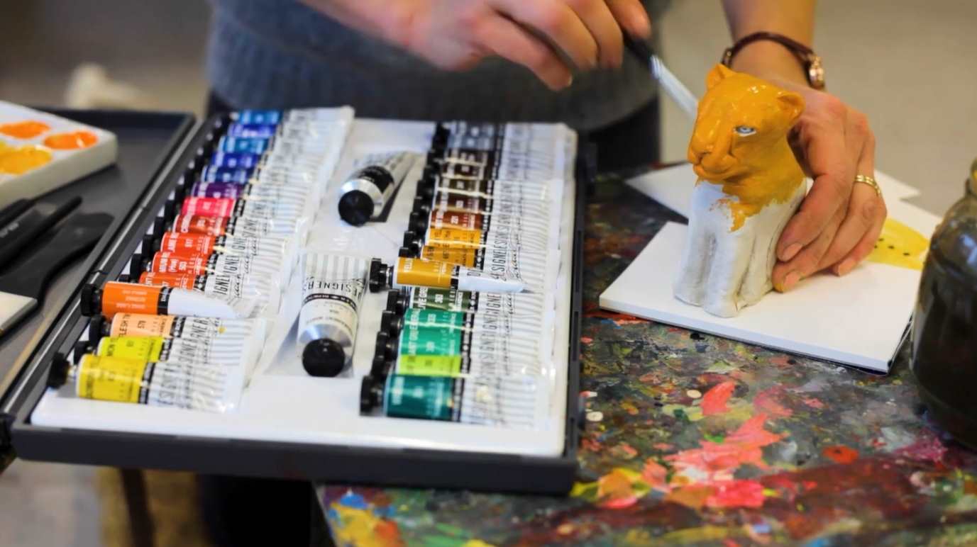 Painter painting yellow leopard model using Daler-Rowney designer gouache